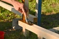 A man with a brush in his hands applies a protective coating to a wood Royalty Free Stock Photo