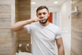 Man brushes his teeth in bathroom, morning hygiene Royalty Free Stock Photo