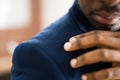 Man Brushing Dandruff From Dirty Suit. Itchy Head Royalty Free Stock Photo