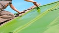 Man Brushing Green Paint onto the Roof Royalty Free Stock Photo