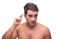 The man brushing his hair isolated on white Royalty Free Stock Photo