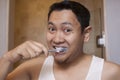 Man Brushing Teeth in Bathroom Royalty Free Stock Photo