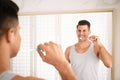 Man brushing teeth in front of mirror at home Royalty Free Stock Photo