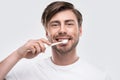 happy man brushing teeth and looking at camera Royalty Free Stock Photo