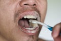 Man brushing teeth with herb toothpaste Royalty Free Stock Photo