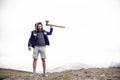 Man brutal bearded hipster with axe stand on mountain top Royalty Free Stock Photo