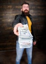 Man brutal bearded hipster wear leather jacket and hold cash money. Illegal profit and black cash. Guy mafia dealer with Royalty Free Stock Photo