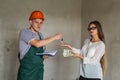 Man builder giving keys from apartment to woman giving money