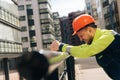 Man builder in helmet closeup, upset in shock, holding his head. Fire fighting concept. house burned down Royalty Free Stock Photo