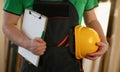 Man builder holding documents and safety helmet in his hands closeup Royalty Free Stock Photo