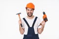 Man builder holding drill and hammer Royalty Free Stock Photo