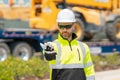 Man builder near excavator. Builder worker with excavator. Builder in helmet. Worker in hardhat. Portrait mechanical