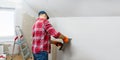 Man builder plastering a wall using a construction trowel. House renovation. Royalty Free Stock Photo