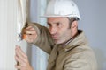Man builder removing wall paper Royalty Free Stock Photo