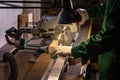 A man builder saws a board with a circular saw in the workshop Royalty Free Stock Photo