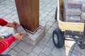 Man building a brick pillar on a wooden gazebo