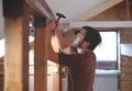 Man building a house and workimg with hammer and wood