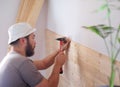 Man building a house and workimg with hammer and wood