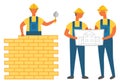 Man Building Wall with Bricks, Engineers with Plan Royalty Free Stock Photo