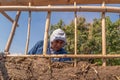 man building a wall with reed and mud, bioconstruction Royalty Free Stock Photo