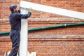 Man builds a house of a wooden beam Royalty Free Stock Photo