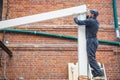 Man builds a house of a wooden beam Royalty Free Stock Photo