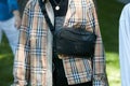 Man with Burberry beige shirt and Adidas black pouch before Giorgio Armani fashion show, Milan Fashion Week