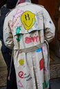 Man with Burberry trench coat with designs before Reshake fashion show, Milan Fashion Week street