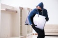 The man burglar stealing tv set from house Royalty Free Stock Photo