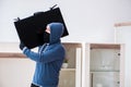 The man burglar stealing tv set from house Royalty Free Stock Photo