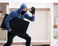 Man burglar stealing tv set from house Royalty Free Stock Photo