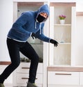 Man burglar stealing tv set from house Royalty Free Stock Photo