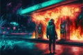 A man burning a gas station at night, under the dim light of the streetlamps, with cars parked in the background Royalty Free Stock Photo