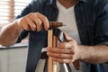 Man burnishing edges of leather belt in workshop Royalty Free Stock Photo