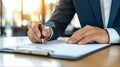 Man in business attire signing a document reflecting professionalism and commitment within a corporate environment Royalty Free Stock Photo