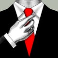 A man in a business suit adjusting his hand with a red tie.
