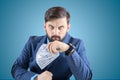 Man in a business suit with banknotes in his hands clenched his fist and looks viciously straight Royalty Free Stock Photo