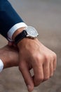 Business suit checking a wrist watch on his hand on background  sea Royalty Free Stock Photo