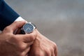 Business suit checking a wrist watch on his hand on background  sea Royalty Free Stock Photo