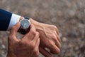 Business suit checking a wrist watch on his hand on background  sea Royalty Free Stock Photo