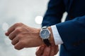 Business suit checking a wrist watch on his hand on background  sea Royalty Free Stock Photo