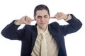 Man in business suit covering his ears with his finger. Royalty Free Stock Photo