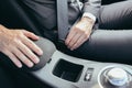 A man in a business suit fastens a car seat belt photo close up Royalty Free Stock Photo