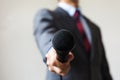 Man in business suit holding a microphone conducting a business Royalty Free Stock Photo