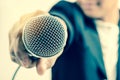 Man in business suit holding a microphone conducting a business Royalty Free Stock Photo