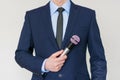 Man in business suit holding a microphone Royalty Free Stock Photo