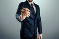 A man in a business suit holds out his hand with a ballpoint pen, writes in the air. Stock for business concept. Close-up, copy Royalty Free Stock Photo