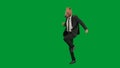 Man in business suit with horse head mask on green studio background. Businessman walking, bouncing and dancing. Concept Royalty Free Stock Photo