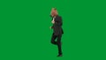 Man in business suit with horse head mask on green studio background. Businessman walking, bouncing and dancing. Concept Royalty Free Stock Photo