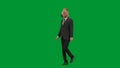 Man in business suit with horse head mask on green studio background. Businessman walking on foot. Concept of hard Royalty Free Stock Photo